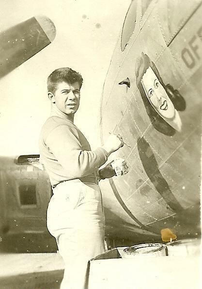 Leonard Wades works on nose art for 